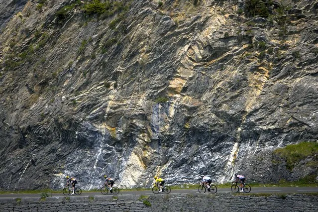Denmark's Jonas Vingegaard, wearing the overall leader's yellow jersey, and Slovenia's Tadej Pogacar, wearing the best young rider's white jersey, speed downhill during the eighteenth stage of the Tour de France cycling race over 143.5 kilometers (89.2 miles) with start in Lourdes and finish in Hautacam, France, Thursday, July 21, 2022. (Photo by Daniel Cole/AP Photo)