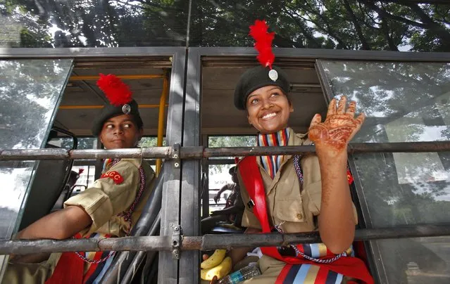 A female National Cadet Corps (NCC) cadet waves with her hand decorated with henna paste, from a bus after taking part in a full dress rehearsal for India's Independence Day celebrations in the northern Indian city of Chandigarh August 13, 2014. India commemorates its Independence Day on August 15. (Photo by Ajay Verma/Reuters)