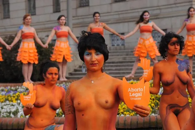 Dozens of women with body paintings take part in a demo in favour of the legalization of abortion in front of the Congress building in Montevideo on September 25, 2012. The Congress is voting a law project which would decriminilize the interruption of pregnancy under certain conditions, including obliging women to set out before a tribunal the reasons for the abortion.  AFP PHOTO/Miguel ROJO        (Photo credit should read MIGUEL ROJO/AFP/GettyImages)