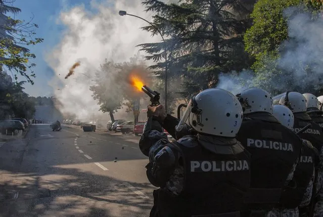 Police fire teargas at opponents of same-s*x rights in Podgorica October 20, 2013. Some 150 supporters of same-s*x rights, guarded by almost 2,000 policemen, staged the first Pride March in the Montenegrin capital on Sunday and hailed it as a herald of better times in the small European Union candidate country. After the tense but incident-free march, scuffles broke out between police and anti-gay opponents in several locations in Podgorica and police used teargas to disperse them, a Reuters reported on the scene said. (Photo by Stevo Vasiljevic/Reuters)