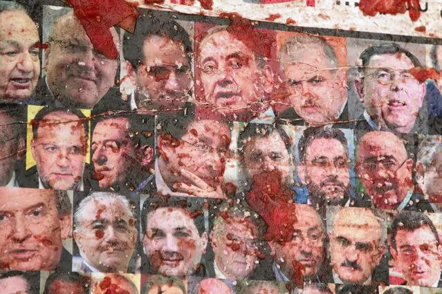 Crushed tomatoes are seen on a poster depicting pictures of Lebanese members of parliament during a protest against perceived government failures, including a rubbish disposal crisis, at Martyrs' Square in downtown Beirut, Lebanon September 9, 2015. (Photo by Aziz Taher/Reuters)