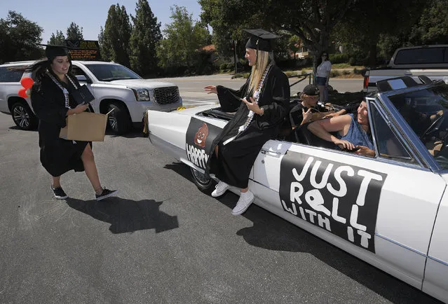 Graduates get back in their car after receiving their diplomas during graduation ceremonies for Oak Park High School, Thursday, June 4, 2020, in the Oak Park section of Ventura County, Calif. (Photo by Mark J. Terrill/AP Photo)