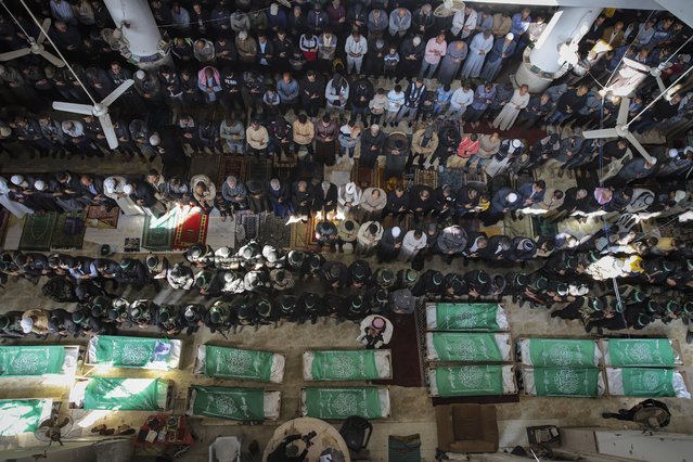 Palestinians pray by the bodies of fifteen members of the Izzedine al-Qassam Brigades, the military wing of Hamas movement, who were killed in Israeli bombardment of the Gaza Strip, in Khan Younis, Friday, January 31, 2025. (Photo by Jehad Alshrafi/AP Photo)