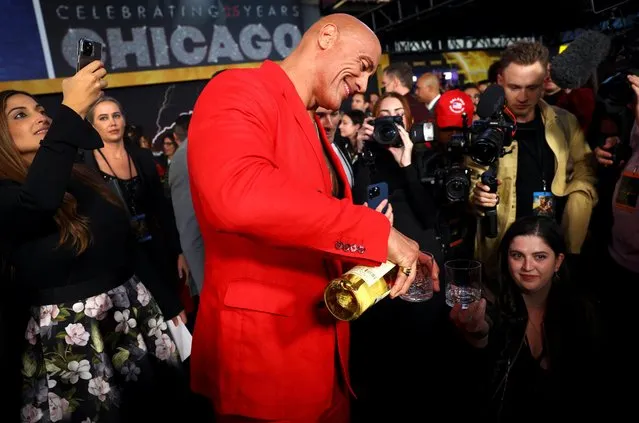Actor Dwayne Johnson pours a glass of his Teremana brand tequila as he arrives for the world premiere of the film “Black Adam” in Times Square in New York City, New York, U.S., October 12, 2022. (Photo by Mike Segar/Reuters)