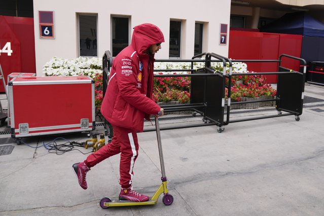 Ferrari driver Lewis Hamilton of Britain rides a scooter during a Formula One pre-season test at the Bahrain International Circuit in Sakhir, Bahrain, Thursday, February 27, 2025. (Photo by Darko Bandic/AP Photo)