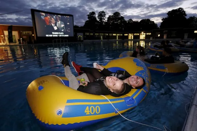 Movie goers smile as they wait to watch a screening of Steven Spielberg's film “Jaws” whilst floating in inflatable dinghies at Brockwell Lido in London, Britain Thursday September 17, 2015. (Photo by Luke MacGregor/Reuters)