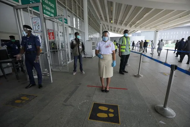 A health worker is seen with an infra-red laser thermometer at the Nnamdi Azikiwe International airport during preparation ahead of the reopening of the airport for domestic flight operations that is scheduled for July 8, 2020 in Abuja, Nigeria on July 6, 2020. (Photo by Afolabi Sotunde/Reuters)
