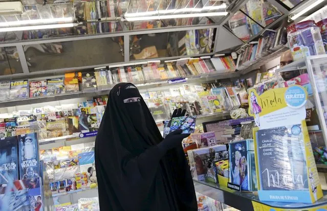 Gisele Marie, a Muslim woman and professional heavy metal musician, holds music CDs in a shop after a rehearsal at her house, in Sao Paulo September 15, 2015. (Photo by Nacho Doce/Reuters)