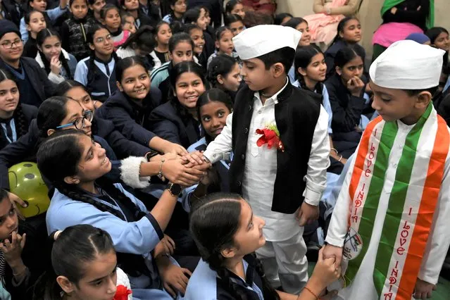 Boys dressed as India's first prime minister Jawaharlal Nehru, gesture during a celebration of Children's day on the occasion of Nehru's 133rd birth anniversary, at a school in Amritsar on November 14, 2022. (Photo by Narinder Nanu/AFP Phoot)