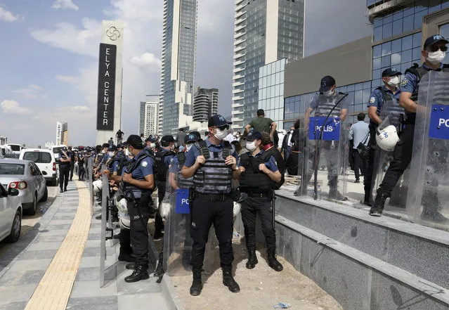 Riot police officers surround the heads of several Turkish lawyers' associations, preventing the group from marching to the capital, Ankara, Turkey, Monday, June 22, 2020. The heads of Bar Associations from various cities embarked on a march to Ankara last week in their robes to protest government plans to amend laws regulating lawyers and their associations. (Photo by Burhan Ozbilici/AP Photo)
