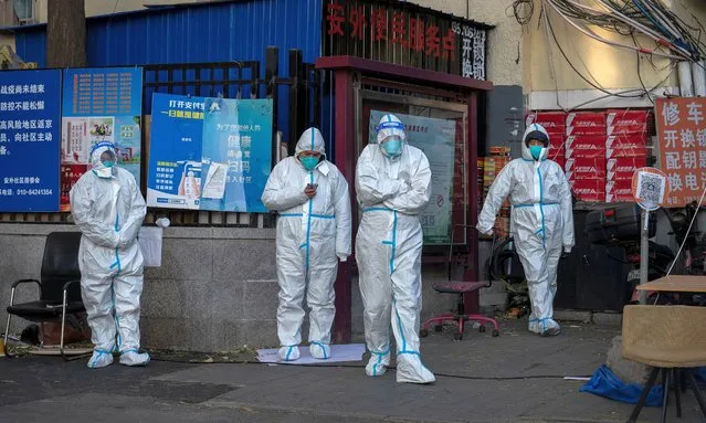 Security guards wear PPE to prevent the spread of COVID-19 as they guard a gate in an area with communities in lockdown and under health monitoring on November 30, 2022 in Beijing, China. In recent days, China has been recording its highest number of COVID-19 cases since the pandemic began, as authorities are sticking to their strict zero tolerance approach to containing the virus with lockdowns, mandatory testing, mask mandates, and quarantines as it struggles to contain outbreaks.In an effort to try to bring rising cases under control, the government last week closed most stores and restaurants for inside dining, switched schools to online studies, and told people to work from home among other measures. (Photo by Kevin Frayer/Getty Images)