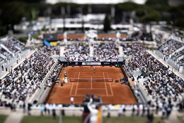 This pictures taken with a tilt and shift lens shows Chile's Nicolas Jarry as he serves to France's Hugo Gaston during their match of the ATP Rome Open tennis tournament at the Foro Italico in Rome on May 8, 2025. (Photo by Marco Bertorello/AFP Photo)