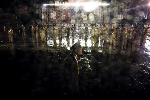 Senior North Korean military officers stand in the rain on Pyongyang's main Kim Il Sung Square after the parade celebrating the 70th anniversary of the founding of the ruling Workers' Party of Korea, in Pyongyang October 10, 2015. (Photo by Damir Sagolj/Reuters)