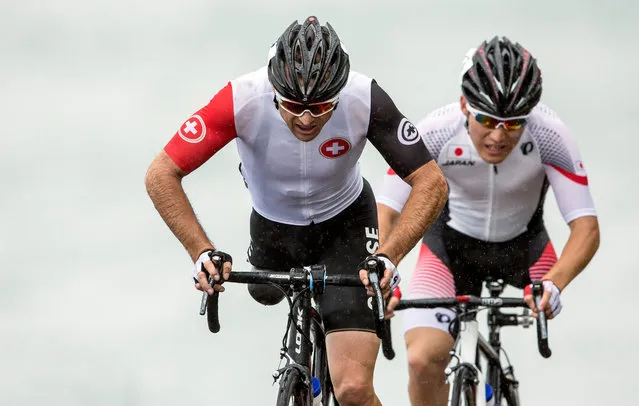 Switzerland's Roger Bolliger (L) and Japan's Shota Kawamoto in action during the men's para-cycling road race in Pontal at the Rio 2016 Paralympic Games in Rio de Janeiro, Brazil, 16 September 2016. (Photo by Alexandra Wey/EPA)