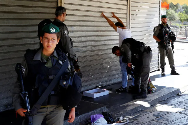 Israeli border policemen perform a body search on a Palestinian following a stabbing attack on two Israeli police officers near Jerusalem's Old City September 19, 2016. (Photo by Ammar Awad/Reuters)