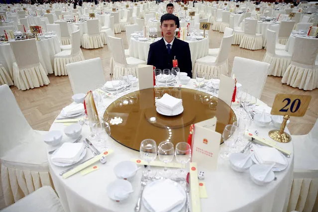 Security agents sit at tables as first guests arrive for the reception to celebrate National Day at the Great Hall of the People in Beijing, China September 30, 2016. (Photo by Damir Sagolj/Reuters)