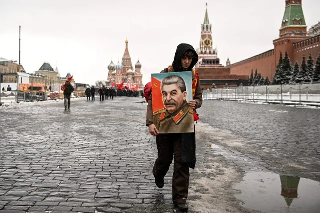 Russian Communist party supporter holds a portrait of late Soviet leader Joseph Stalin as she leaves a memorial ceremony to mark the 70th anniversary of his death at Red Square in Moscow on March 5, 2023. (Photo by Kirill Kudryavtsev/AFP Photo)