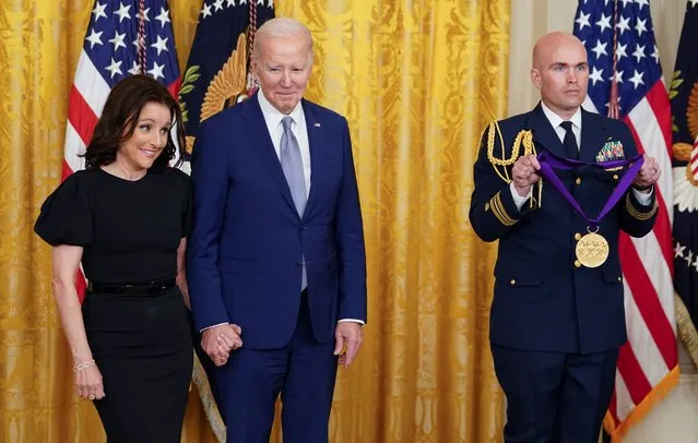 National Medal of Arts recipient actor Julia Louis-Dreyfus holds hands with U.S. President Joe Biden as she waits to be presented her medal during a ceremony in the East Room at the White House in Washington, U.S., March 21, 2023. (Photo by Kevin Lamarque/Reuters)