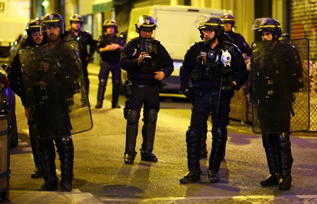 Law enforcement officers keep watch as protesters demonstrate against the French far-right Rassemblement National (National Rally - RN) party, following partial results in the first round of the early 2024 legislative elections, at the Place de la Republique in Paris, France, on June 30, 2024. (Photo by Fabrizio Bensch/Reuters)