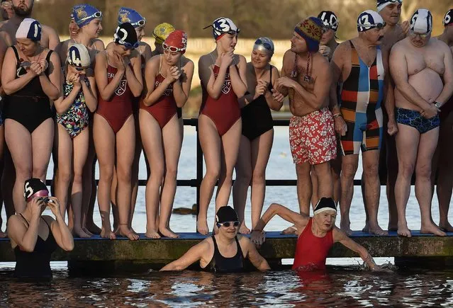 Competitors take part in the Peter Pan Cup open water swim in the Serpentine Lake at Hyde Park in London, December 25, 2014. Over one hundred swimmers took part in the annual Christmas Day event, swimming in water temperatures of 3-5 degrees celsius. (Photo by Toby Melville/Reuters)