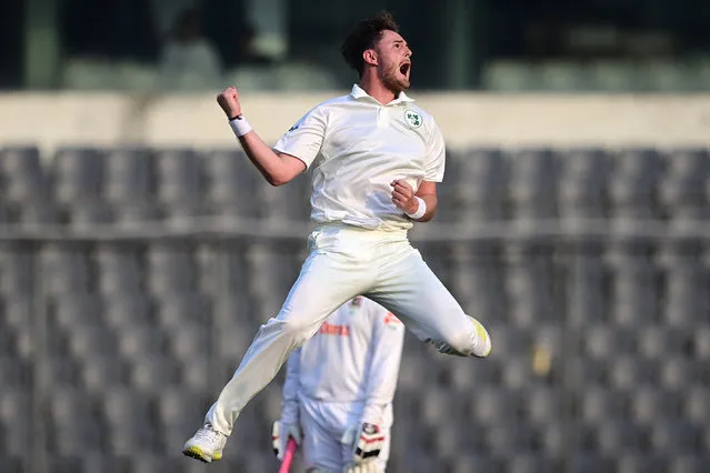 Ireland's Mark Adair celebrates after taking the wicket of Bangladesh's Najmul Hossain Shanto (not pictured) during the first day of the Test cricket match between Bangladesh and Ireland at the Sher-e-Bangla National Cricket Stadium in Dhaka on April 4, 2023. (Photo by Munir Uz Zaman/AFP Photo)