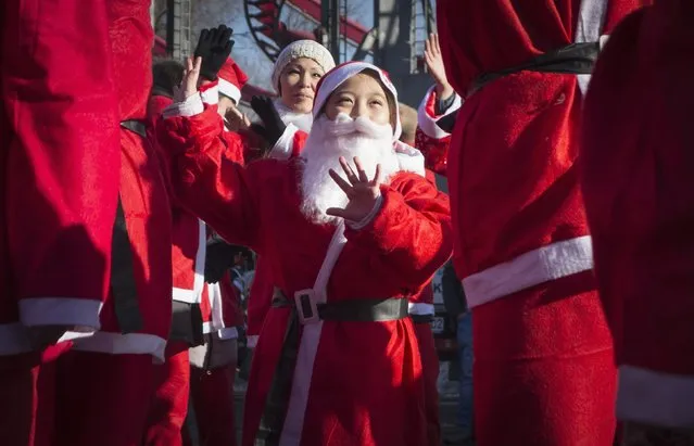 Revelers dressed as Father Frost, the equivalent of Santa Claus, dance during a parade in Almaty December 28, 2014. (Photo by Shamil Zhumatov/Reuters)