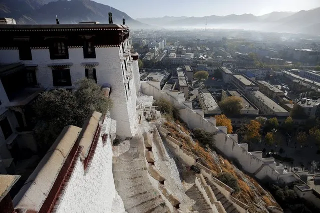 Morning mist covers downtown as seen from atop the Potala Palace in Lhasa, Tibet Autonomous Region, China November 17, 2015. (Photo by Damir Sagolj/Reuters)