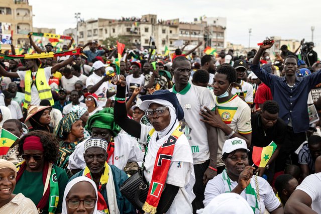 A supporter of Senegal's Prime Minister Ousmane Sonko dances during a rally in Dakar, on November 8, 2025. (Photo by Patrick Meinhardt/AFP Photo)