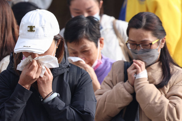 Relatives react after identifying family members from photos at Kwong Fuk Community Hall following the Wang Fuk Court housing estate fire, in Tai Po, Hong Kong, China, on November 27, 2025. (Photo by Tyrone Siu/Reuters)