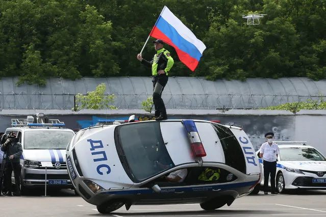 Members of the Kaskad (Cascade) stunt team perform in Moscow, Russia on July 3, 2020 on the parade ground of the 2nd Separate Special Purpose Battalion of the Road Patrol Service under the General Traffic Safety Administration (GIBDD) on Traffic Police Day annually celebrated on July 3 in Russia. (Photo by Vladimir Gerdo/TASS)