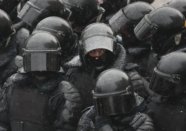 Police stand blocking approaches to the street during a protest against the jailing of opposition leader Alexei Navalny in Moscow, Russia, Sunday, January 31, 2021. (Photo by Andrew Lubimov/AP Photo)