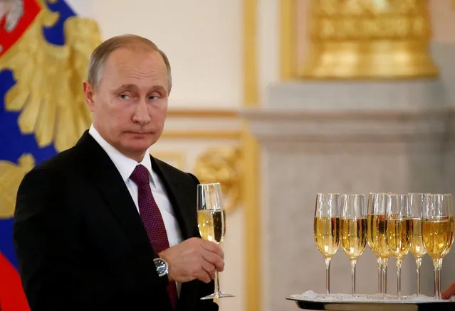 Russia's President Vladimir Putin holds a glass during a ceremony of receiving diplomatic credentials from foreign ambassadors at the Kremlin in Moscow, Russia, November 9, 2016. (Photo by Sergei Karpukhin/Reuters)