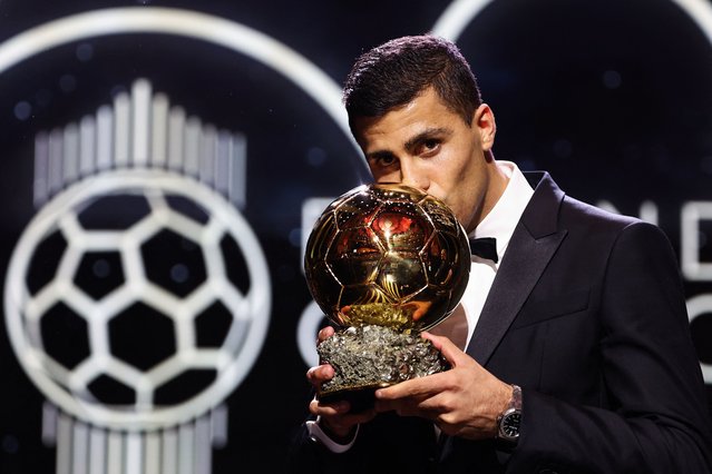 Manchester City's Spanish midfielder Rodri kisses the trophy as he receives the Ballon d'Or award during the 2024 Ballon d'Or France Football award ceremony at the Theatre du Chatelet in Paris on October 28, 2024. (Photo by Franck Fife/AFP Photo)