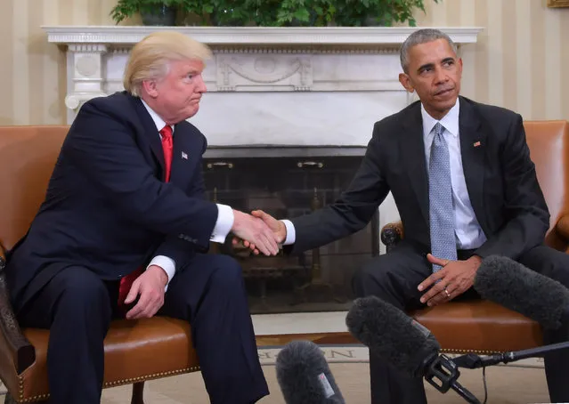 US President Barack Obama and President-elect Donald Trump shake hands during a transition planning meeting in the Oval Office at the White House on November 10, 2016 in Washington, DC. (Photo by Jim Watson/AFP Photo)