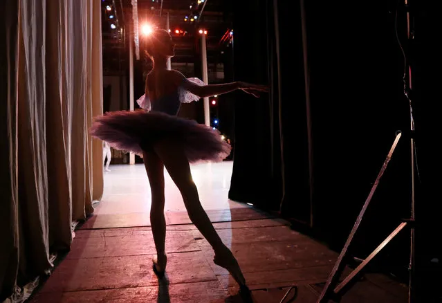 A contestant prepares backstage before performing at the “Grand Prix of Siberia” international ballet competition, held as part of the 4th International Forum “Ballet. XXI Century”, at the State Opera and Ballet Theatre in Krasnoyarsk, Siberia, Russia, November 11, 2016. (Photo by Ilya Naymushin/Reuters)