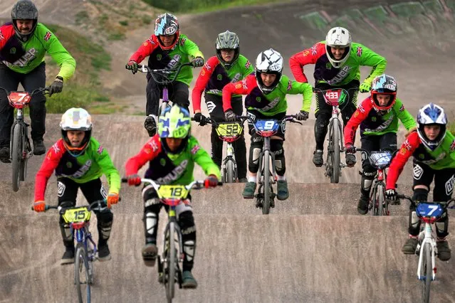 British BMX rider Sarah-Jane Nichols (3R) goes over a jump alongside young riders during a training session at Andover BMX club in southern England on June 14, 2023. Known as the “Godmother of BMX”, Nichols is making a comeback in the sport at the age of 53. Nichols, who retired in 1988, was seven times British champion, four times European, and the 1986 World Champion. She was inducted into the British BMX Hall of Fame as the first female racer at a ceremony in Birmingham last year. (Photo by Adrian Dennis/AFP Photo)