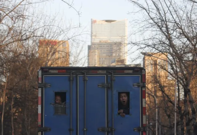 A man riding a truck yawns in Beijing, China, December 18, 2015. (Photo by Kim Kyung-Hoon/Reuters)