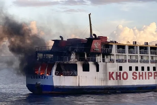 In this handout photo provided by the Philippine Coast Guard, smoke comes out from Philippine ferry M/V Esperanza Star as it caught fire at the waters off Panglao, Bohol province, central Philippines on Sunday, June 18, 2023. The Philippine ferry carrying up to 65 passengers and crew members caught fire at sea on Sunday and a coast guard vessel was deployed to rescue those onboard and try to extinguish the flames, coast guard officials said. (Photo by Philippine Coast Guard via AP Photo)