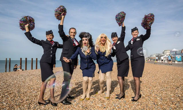 Drag Queens Crystal Couture (l) and Domini (r) pose for a photo with British Airways Ambassadors on the beach to mark the start of Brighton Pride, which is being partnered by British Airways on August 4, 2018 in Brighton, England. (Photo by Tim P. Whitby/Getty Images for British Airways)