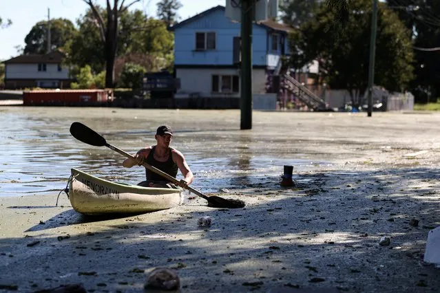 A local resident paddles a kayak over a flooded street as severe flooding affects the suburb of Windsor after days of heavy rain in the state of New South Wales, in Sydney, Australia, March 24, 2021. (Photo by Loren Elliott/Reuters)