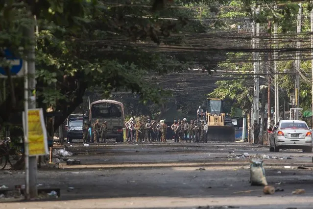 Army and police gather during a demonstration against the military coup in Kyauk Myaung Township, Yangon, Myanmar, Saturday, April 3, 2021. (Photo by AP Photo/Stringer)