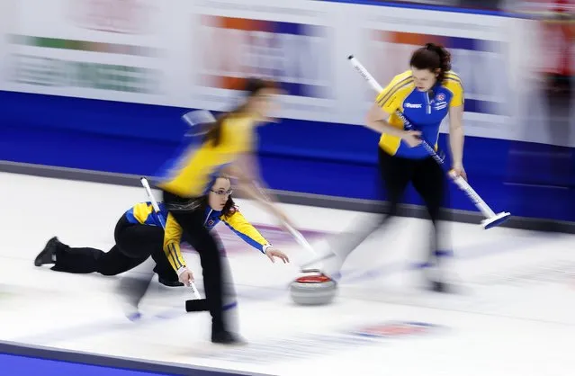 Alberta skip Val Sweeting delivers her rock with teammates lead Rachelle Brown (L) and second Dana Ferguson (R) in their game against Team Canada and during the Scotties Tournament of Hearts in Moose Jaw, Saskatchewan, February 19, 2015. (Photo by Todd Korol/Reuters)