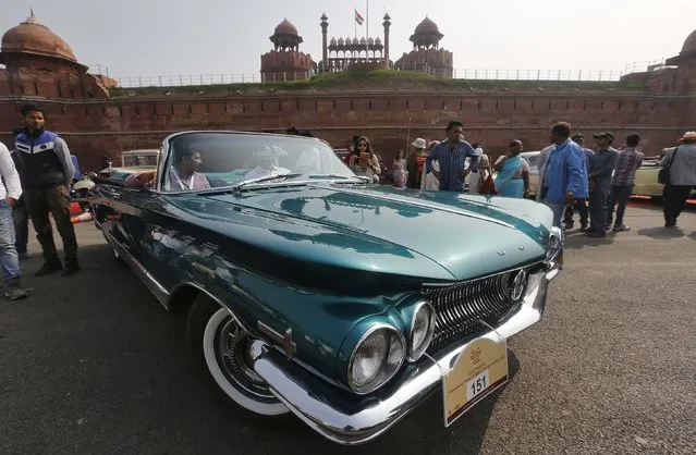 A participant drives his 1960 Buick car during a vintage car rally in front of the historic Red Fort in the old quarters of Delhi February 21, 2015. (Photo by Adnan Abidi/Reuters)