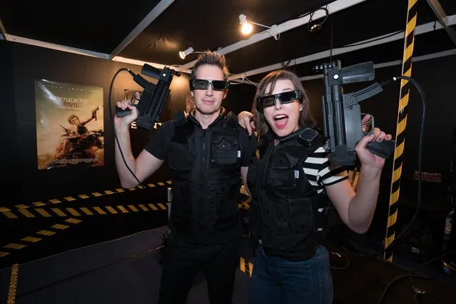 Director Paul W.S. Anderson & Milla Jovovich experience Road to Raccoon City- Resident Evil: The Final Chapter - featuring Sony's interaction technology at CineAsia. (Photo by Brent NG/Invision for Sony Pictures Entertainment/AP Images)