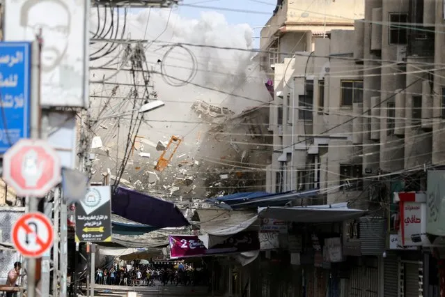 Debris fly as smoke rises following an Israeli air strike, amid Israeli-Palestinian fighting, in Khan Younis in the southern Gaza Strip, May 20, 2021. (Photo by Ibraheem Abu Mustafa/Reuters)
