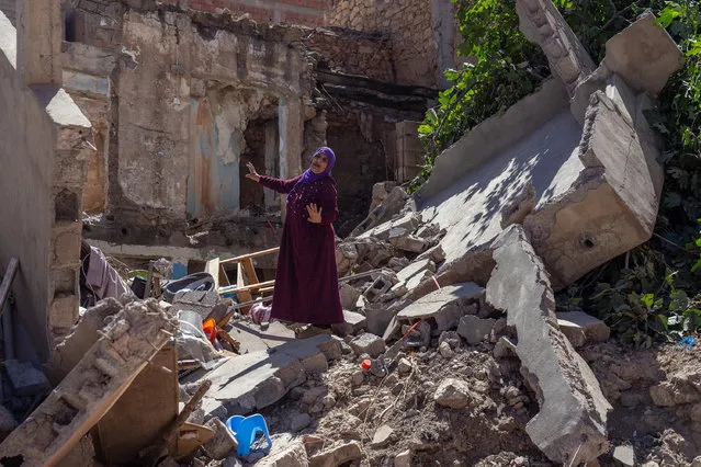 A woman gestures as she stands amongst the rubble of her home that was destroyed by yesterday's earthquake, on September 10, 2023 in Moulay Brahim, Morocco. A huge earthquake measuring 6.8 on the Richter scale has hit central Morocco. Whilst the epicentre was in a sparsely populated area of the High Atlas Mountains, its effects have been felt 71km away in Marrakesh, a major tourist destination, where many buildings have collapsed and thousands of deaths have been reported. (Photo by Carl Court/Getty Images)