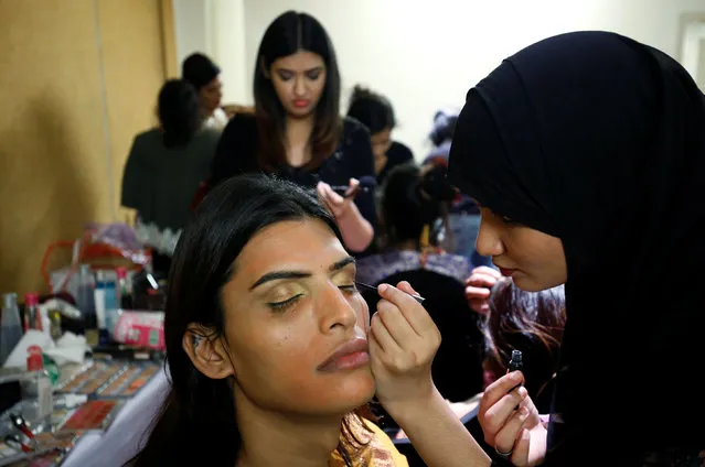 A contestant prepares at the backstage before the Miss Transqueen India 2018 transgender beauty pageant in Mumbai, India on October 7, 2018. (Photo by Francis Mascarenhas/Reuters)