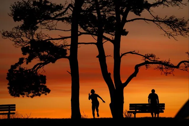 Early-risers take part in an exercise program at dawn in Bug Light Park, Wednesday, September 20, 2023, in South Portland, Maine. Most of the state is enjoying a pleasant, dry stretch of weather that should last through Saturday. (Phoot by Robert F. Bukaty/AP Photo)