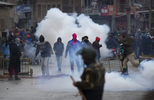 Kashmiri Muslim protesters hold bricks and stones to throw at Indian police and paramilitary soldiers during a protest in Srinagar, Indian controlled Kashmir, Friday, January 29, 2016. Police fired teargas and rubber bullets to disperse Kashmiris who gathered after Friday afternoon prayers to protest against Indian control over a part of the disputed region. (Photo by Dar Yasin/AP Photo)