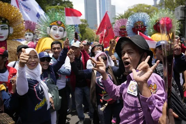 Supporters of presidential candidate Ganjar Pranowo cheer as they wait for his arrival to officially register his candidacy to run in the 2024 election, at the General Election Commission building in Jakarta, Indonesia, Thursday, October 19, 2023. The world's third-largest democracy is set to vote in simultaneously legislative and presidential elections on Feb. 14, 2024. (Photo by Achmad Ibrahim/AP Photo)